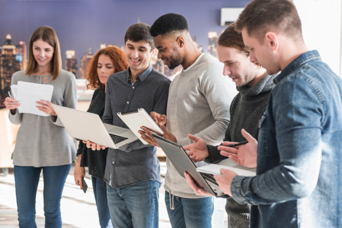 Standing adults in a choir holding sheet music.